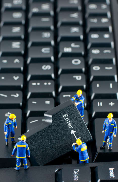 Team of construction workers working on a computer keyboard