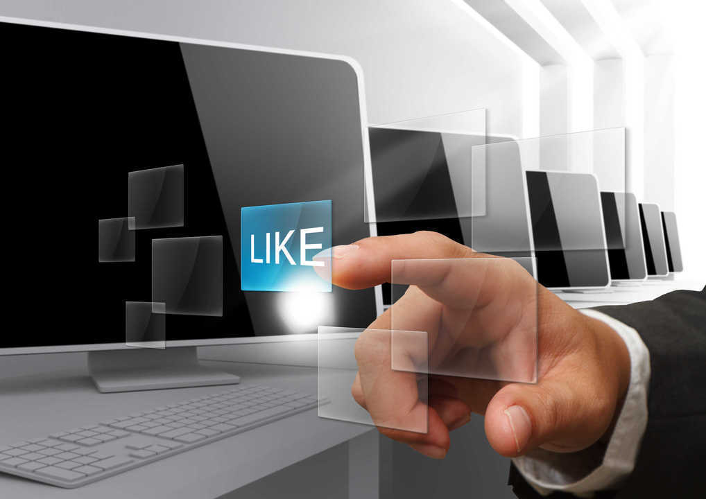 Hand pressing Like button