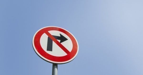 Low angle view of no right turn sign against clear sky