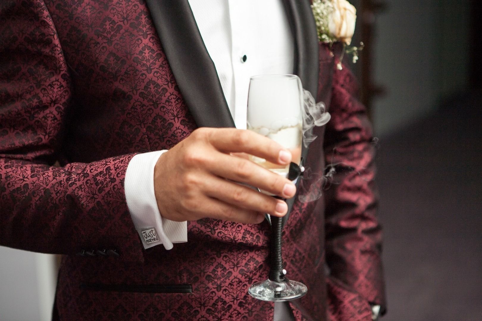 Close up of man holding a glass of champagne in hand