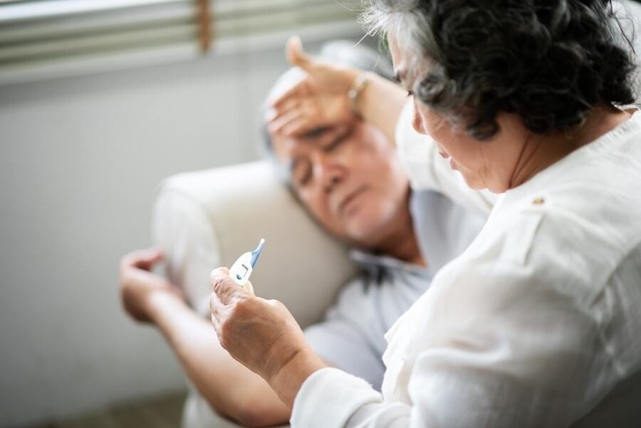 Sick Senior Man Lying On Couch