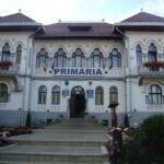 Șofer la volanul unui microbuz școlar galben, pregătit pentru transportul copiilor.