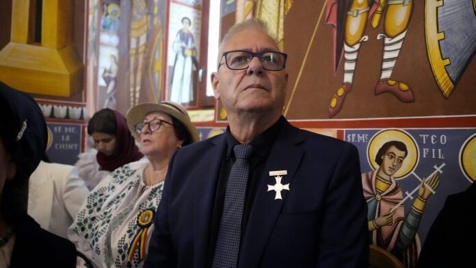 Gheorghe Huja în timpul unei interpelări publice, așteptând un răspuns de la autorități.