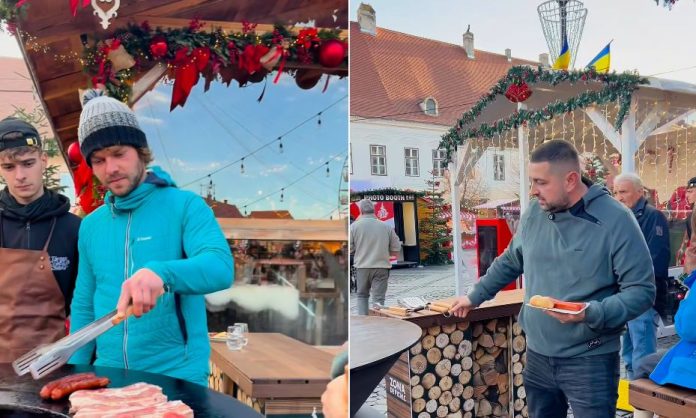 Zona de picnic a Târgului de Crăciun din Sibiu, cu mese de lemn și decorul festiv.