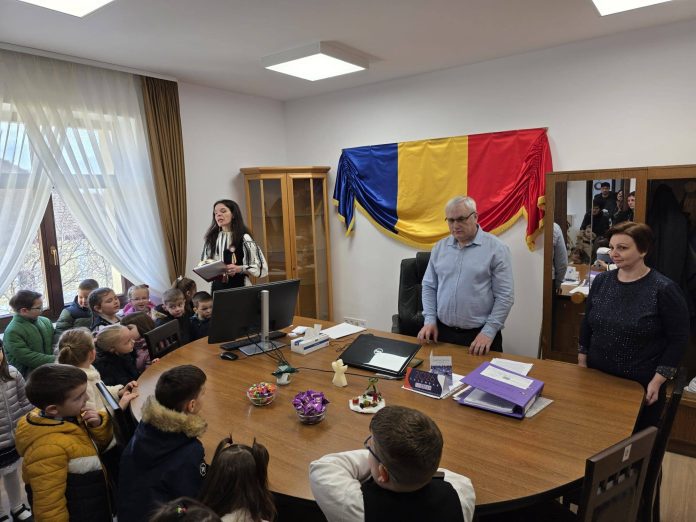 Fațada Primăriei Comunei Boița, decorată pentru sărbători, cu copii în prim-plan