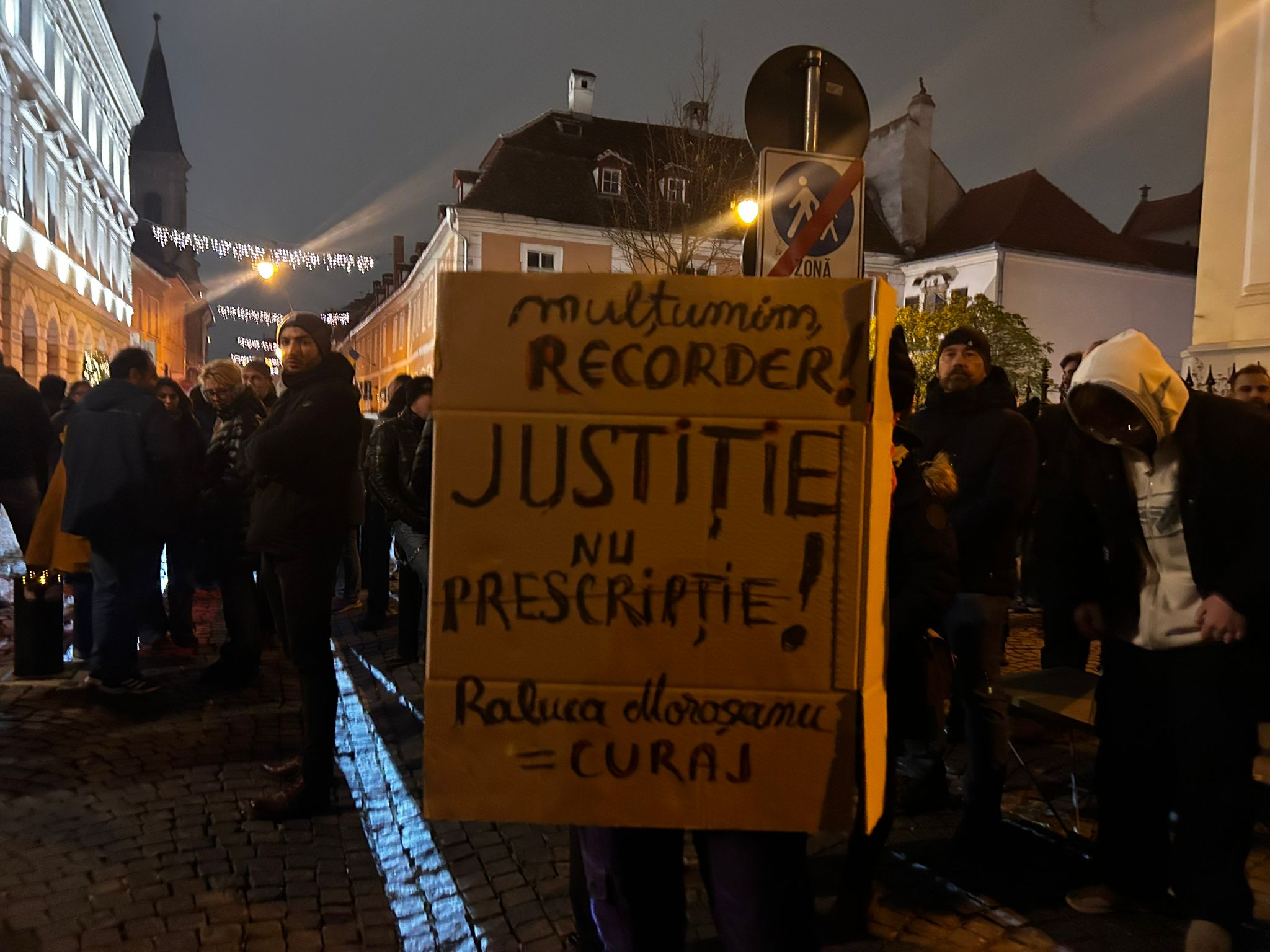 Protestatari tineri ținând pancarta principală cu revendicări de justiție