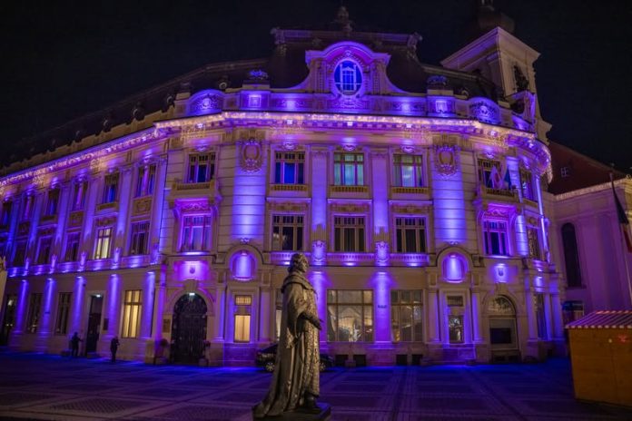 Primăria Sibiu iluminată în mov pentru Ziua Dizabilităților, sprijinind campania Purple Night Romania