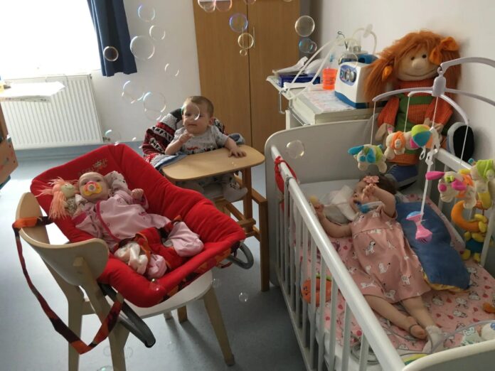 Cadru emoționant al unui voluntar care citește unui copil în hospice-ul din Sibiu