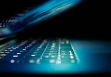 Bărbat din Ilfov, reținut la Sibiu pentru înșelăciune și infracțiuni informatice Un laptop deschis pe un birou, ilustrând uneltele folosite pentru infracțiuni informatice și înșelăciune.