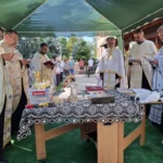 Credincioși participând la liturghie în curtea bisericii spitalului din Sibiu